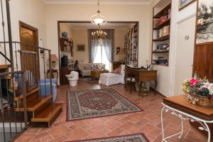 a living room with a staircase and a living room with a rug at Patrian in Grottaferrata
