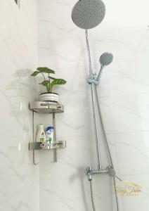 a shower with two shelves in a bathroom at Song Trân House in Xã Tân Phát
