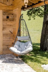 a swing hanging from a pergola at Ferienparadies Taxen in Sankt Veit im Pongau