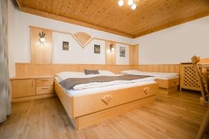 a bedroom with two beds and a wooden ceiling at Ferienparadies Taxen in Sankt Veit im Pongau +66 photos