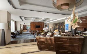 a lobby of a hotel with a bar and a dining room at Four Seasons Hotel Beijing in Beijing