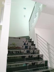 a staircase in a building with black and white at Bonda Lilik Homestay in Klang