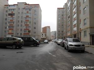 a street with cars parked in a parking lot at Forrest for 8 person in Luts'k