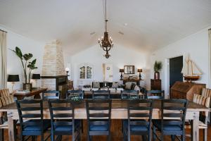 a dining room with a large wooden table and chairs at Corunna Station Country House in Belford