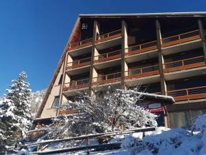 a large building with snow in front of it at Appartement Saint-Michel-de-Chaillol, 2 pièces, 6 personnes - FR-1-393-51 in Saint-Michel-de-Chaillol