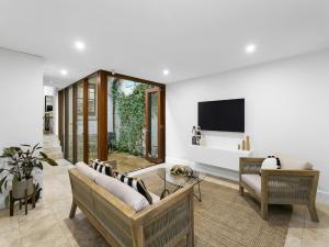 a living room with a couch and a tv at WIND82D - Windmill at Dawes in Sydney