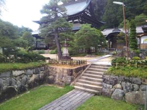 a temple with a stone wall and stairs in front at Tomareru sento taka no yu - Vacation STAY 00556v in Takayama