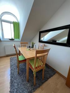 a dining room with a table and chairs and a mirror at Vienna Excellent Apartments in Vienna