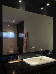 a bathroom with a sink and a large mirror at Cede Boutique Beach Resort in Ko Phayam +19 photos