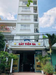 a white building with a sign that reads cat them sa at Hotel Cát Tiên Sa in Ho Chi Minh City