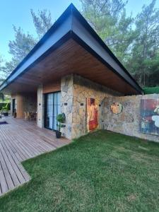 a house with a stone wall and a patio at Metavilla in Kemer