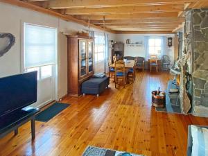 a living room with a table and a dining room at Holiday home byrknesøy in Ånneland