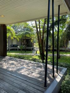 a porch of a house with a wooden deck at Cede Boutique Beach Resort in Ko Phayam