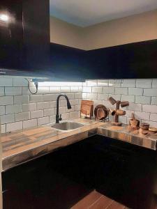 a kitchen with a sink and a counter top at IV’s Condo w/ Netflix and Wi-Fi in Cainta