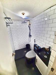 a small bathroom with a toilet and a sink at IV’s Condo w/ Netflix and Wi-Fi in Cainta
