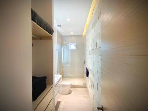 a small bathroom with a toilet and a wall at 1st Luxury Warehouse in Cancún