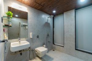 a bathroom with a sink and a toilet and a shower at Idyll Hills by VEO - Part of StayVista in Panchgani +15 photos
