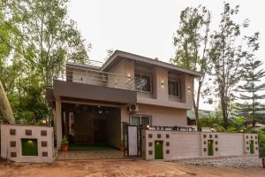 a house with a fence in front of it at Idyll Hills by VEO - Part of StayVista in Panchgani