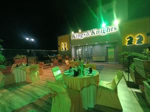 a restaurant with tables and chairs in front of a building at Clarks Inn Express Udaipur in Udaipur