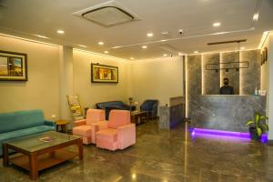 a lobby with a waiting room with a man in the mirror at Four Leaf Hotel - Sapphire Blue, Varanasi in Varanasi