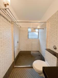 a bathroom with a shower and a toilet in it at Rainforest - Casa Del Sol, Anjuna - 3 kms from the beach in Anjuna
