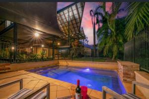 a swimming pool in the middle of a house at ZenLux: 3-Story Corporate Golf Retreat + Pool/BBQ in Knuckeys Lagoon