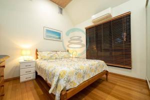 a bedroom with a bed and a window at ZenLux: 3-Story Corporate Golf Retreat + Pool/BBQ in Knuckeys Lagoon +11 photos