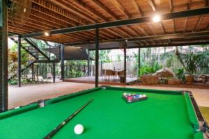 a pool table in the middle of a room at ZenLux: 3-Story Corporate Golf Retreat + Pool/BBQ in Knuckeys Lagoon