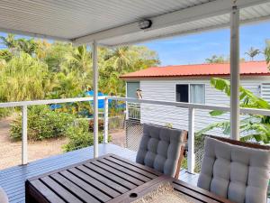 a screened porch with two chairs on a house at Magnetic Haven Unit 5 in Arcadia