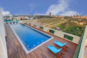 a balcony with a swimming pool on top of a building at Holiday Inn Bengaluru Racecourse, an IHG Hotel in Bangalore
