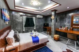 a bedroom with a bed and a desk at Areeya Phubeach Resort in Ao Nang Beach