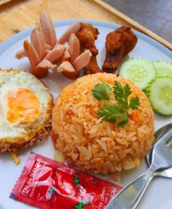 a plate of food with rice and meat and vegetables at Areeya Phubeach Resort in Ao Nang Beach