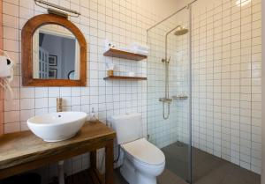 a bathroom with a sink and a toilet and a shower at Le Soleil Boutique Hotel in Da Lat