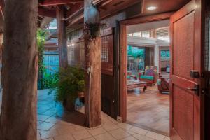 an open door to a room with a potted plant at The Kulani Maui in Lahaina