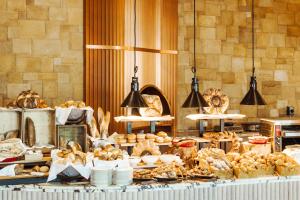 a display of bread and pastries on a table at Hyde Hotel Dubai in Dubai