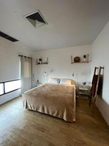 a bedroom with a large bed and a wooden floor at Centerpoint Koh Phangan New in Thong Sala