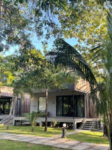 a building with trees in front of it at Cede Boutique Beach Resort in Ko Phayam