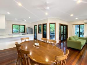 a kitchen and living room with a wooden table and chairs at Mills Cottage in Arcadia