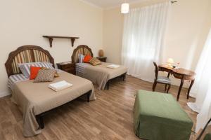 a small room with two beds and a table at Patrian in Grottaferrata
