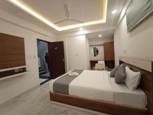 a bedroom with a large bed in a room at Royal N Deluxe in Bangalore