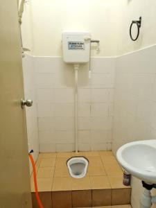 een kleine badkamer met een toilet en een wastafel bij HOMESTAY ALFARUQI GAMBANG (5) in Kampong Pohoi
