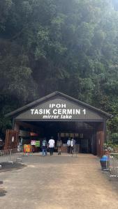a group of people standing outside of a taksidis germaniuminator lodge at Angel Spa Garden's Homestay in Ipoh +24 photos