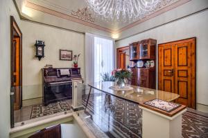 eine Küche mit einem Glastisch und einem Kronleuchter in der Unterkunft Palazzo Stunis - Dimora di Charme in Ostuni