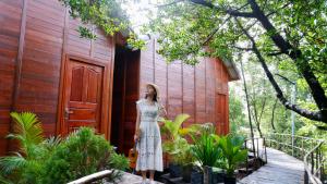 a woman in a dress standing outside of a building at Prek Kdat Resort in Kampot