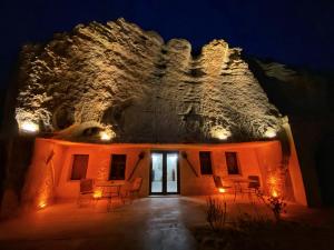 a house with lights on it at night at Milagre Cave Hotel in Göreme
