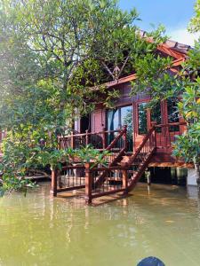 a house on the water in a flooded area at Prek Kdat Resort in Kampot