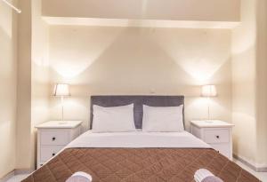 a bedroom with a large bed with two night stands at Simple in Athens