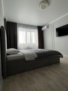 Katil atau katil-katil dalam bilik di Апартаменты люкс класса