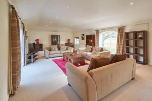 a living room with two couches and a tv at Host & Stay - Folkton Cottages in Scarborough