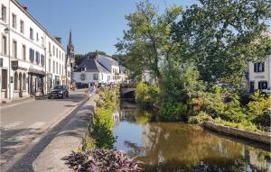 a city street with a river in a town at Amazing Home In Bannalec With Kitchenette in Bannalec